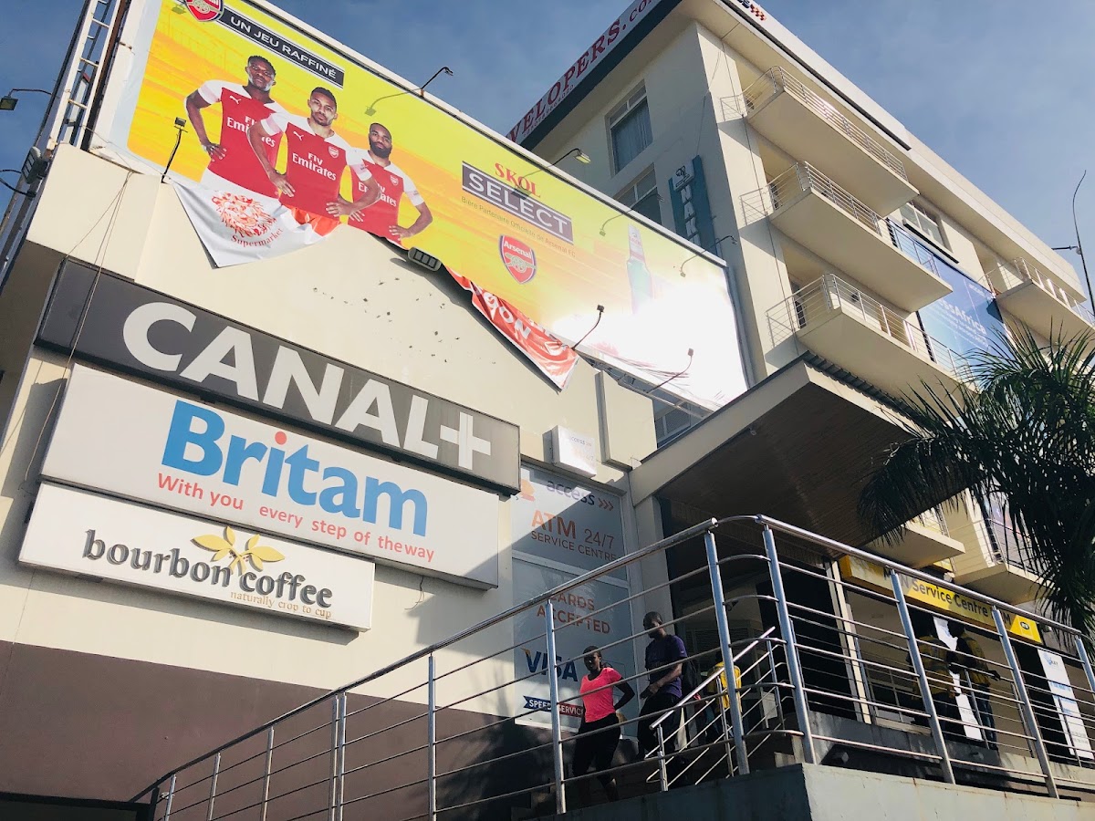 Bourbon Coffee in Kigali — Rwandan coffee that travels in both directions across the customs line, exported as bean and imported back as branded brew
